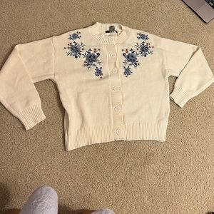 White knit sweater with blue embroidered flowers